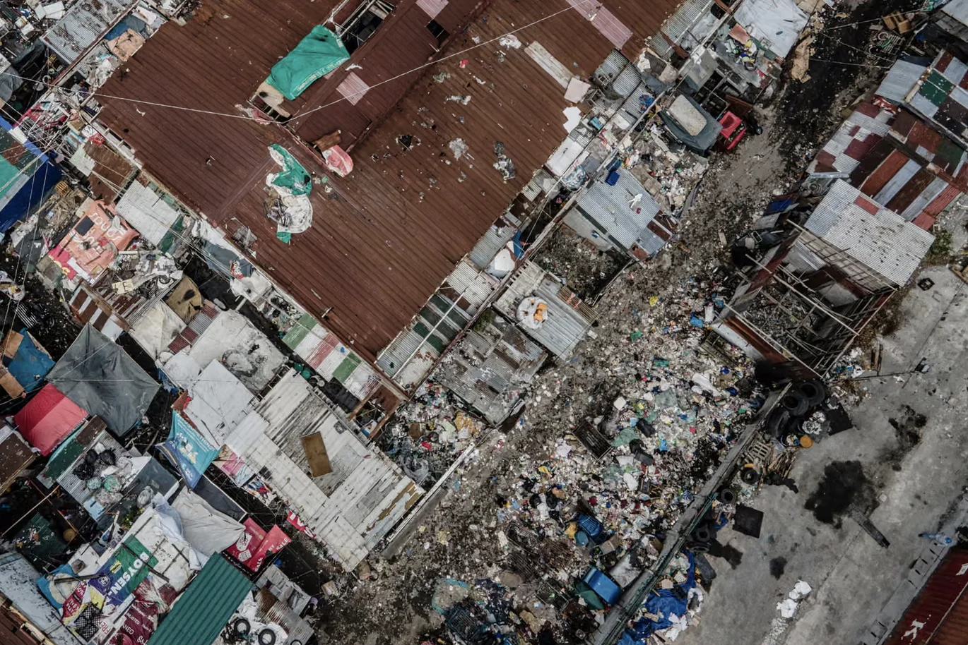Overhead view of densely packed roofs and narrow lanes.